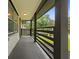 Covered front porch featuring a gray horizontal metal railing and overhead light at 1553 Mccallie Nw Blvd, Atlanta, GA 30318