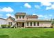 A two-story home with a tan exterior, a well-maintained lawn, and a covered back patio at 1626 Waterchase Dr, Dacula, GA 30019