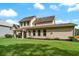 A two-story home with a tan exterior, a well-maintained lawn, and a covered back patio at 1626 Waterchase Dr, Dacula, GA 30019