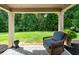 Covered back patio with a view of the expansive, tree-lined backyard at 1626 Waterchase Dr, Dacula, GA 30019