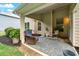 Back patio with a wicker chair and a rocking chair with a cushioned rug at 1626 Waterchase Dr, Dacula, GA 30019
