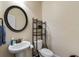 Half bathroom with pedestal sink and decorative mirror at 1626 Waterchase Dr, Dacula, GA 30019
