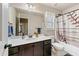 Bathroom featuring a quartz countertop, a big mirror and a tub with a modern shower curtain at 1626 Waterchase Dr, Dacula, GA 30019