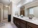Bathroom with double sink vanity, a large mirror, and well-lit modern fixtures at 1626 Waterchase Dr, Dacula, GA 30019