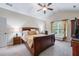 Spacious bedroom featuring a cozy bed, a ceiling fan, and natural light from the window at 1626 Waterchase Dr, Dacula, GA 30019