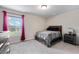 Bedroom featuring a dark wood bed frame, carpeted floors, and a window view at 1626 Waterchase Dr, Dacula, GA 30019
