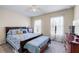 Comfortable bedroom featuring a ceiling fan and natural light from bright windows at 1626 Waterchase Dr, Dacula, GA 30019