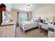 Bright bedroom with a light wood bed frame, carpeted floors, and a window view at 1626 Waterchase Dr, Dacula, GA 30019