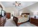 Comfortable bedroom with ample space, complete with a ceiling fan and coordinated furnishings at 1626 Waterchase Dr, Dacula, GA 30019