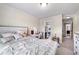 Bedroom with a white wood bed frame, a desk, and an en-suite bathroom at 1626 Waterchase Dr, Dacula, GA 30019