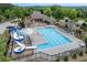 Aerial view of community pool with slides, chairs, and a clubhouse at 1626 Waterchase Dr, Dacula, GA 30019