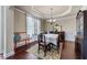 Traditional dining room with hardwood floors, crown molding, and classic furniture at 1626 Waterchase Dr, Dacula, GA 30019