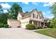 Side view of a home with a three-car garage and a well-maintained lawn on a sunny day at 1626 Waterchase Dr, Dacula, GA 30019