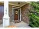 Inviting front entrance with a stone facade, decorative wreath, and well-manicured landscaping at 1626 Waterchase Dr, Dacula, GA 30019