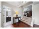 Hallway leading to a lower level and bathroom, featuring wooden floors and a decorative table at 1626 Waterchase Dr, Dacula, GA 30019
