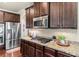 Close up of kitchen featuring granite countertops, stainless steel appliances, and dark cabinets at 1626 Waterchase Dr, Dacula, GA 30019