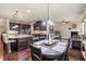 Open concept kitchen and dining area with dark wood floors and modern lighting at 1626 Waterchase Dr, Dacula, GA 30019