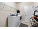 Laundry room equipped with a washer and dryer set and shelving at 1626 Waterchase Dr, Dacula, GA 30019