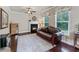 Cozy living room featuring a fireplace, hardwood floors, and natural light at 1626 Waterchase Dr, Dacula, GA 30019