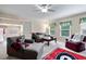 Spacious living room with comfortable seating, a ceiling fan, and natural light from bright windows at 1626 Waterchase Dr, Dacula, GA 30019