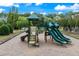 A community playground with slides, climbing structure, and safety ground cover at 1626 Waterchase Dr, Dacula, GA 30019