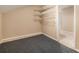 Unfinished basement featuring neutral colored walls and grey carpet flooring at 2132 Wrights Mill Ne Cir, Atlanta, GA 30324