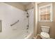 Bright bathroom with white tiled shower/tub and window at 2132 Wrights Mill Ne Cir, Atlanta, GA 30324