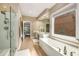 Bright bathroom with dual vanity, stand alone tub and a glass shower at 2132 Wrights Mill Ne Cir, Atlanta, GA 30324
