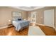 Bedroom with hardwood floors, blue bedding, and ensuite bathroom access at 2132 Wrights Mill Ne Cir, Atlanta, GA 30324