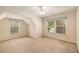Spacious bedroom featuring neutral carpet, ample natural light from two windows, and a ceiling fan at 2132 Wrights Mill Ne Cir, Atlanta, GA 30324