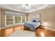 Bedroom with hardwood floors, large window with blinds, tray ceiling, ceiling fan and a neutral color palette at 2132 Wrights Mill Ne Cir, Atlanta, GA 30324