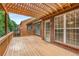 Spacious wooden deck features a charming pergola, offering a great outdoor living and entertaining space at 2132 Wrights Mill Ne Cir, Atlanta, GA 30324