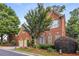 Beautifully landscaped brick two-story house with a two-car garage and flowering trees in the front yard at 2132 Wrights Mill Ne Cir, Atlanta, GA 30324