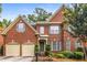 Beautiful two-story brick home boasts an attached two-car garage, a meticulously landscaped front yard, and an inviting entrance at 2132 Wrights Mill Ne Cir, Atlanta, GA 30324
