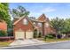 Attractive brick two-story home featuring an attached two-car garage, landscaped yard, and inviting entryway at 2132 Wrights Mill Ne Cir, Atlanta, GA 30324