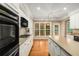 Bright kitchen with stainless steel appliances, island, and wooden floor at 2132 Wrights Mill Ne Cir, Atlanta, GA 30324