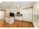 Open kitchen featuring hardwood floors, an island and white cabinetry at 2132 Wrights Mill Ne Cir, Atlanta, GA 30324