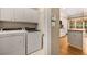 Laundry room with a washer and dryer adjacent to the kitchen at 2132 Wrights Mill Ne Cir, Atlanta, GA 30324