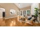 Sun-filled living room featuring hardwood flooring, large windows, and a peek into the eat-in kitchen at 2132 Wrights Mill Ne Cir, Atlanta, GA 30324