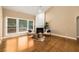 Comfortable living room featuring a cozy fireplace, hardwood floors, and large windows with a view of the backyard at 2132 Wrights Mill Ne Cir, Atlanta, GA 30324