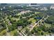 Expansive aerial view showcasing the property's location near parks, schools, and community amenities in a lush, green neighborhood at 47 Powder Springs St, Hiram, GA 30141