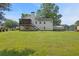 Expansive backyard with a deck, screened porch, and mature trees, perfect for outdoor relaxation and entertainment at 47 Powder Springs St, Hiram, GA 30141