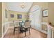 Traditional dining room with hardwood floors, cream color walls, and a glass table at 47 Powder Springs St, Hiram, GA 30141