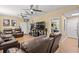 Spacious living room with two ceiling fans and two leather couches at 47 Powder Springs St, Hiram, GA 30141