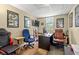 Home office space with hardwood floors, natural lighting, desk, chairs, and a guitar at 47 Powder Springs St, Hiram, GA 30141