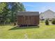 A shed in a fenced yard, offering storage, workspace, and security at 47 Powder Springs St, Hiram, GA 30141