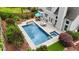 Aerial view of a backyard with a pool, spa, patio area, and beautifully landscaped surroundings at 520 Weatherend Ct, Johns Creek, GA 30022