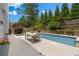 Backyard featuring a swimming pool, patio area, lush landscaping, and outdoor seating for relaxation at 520 Weatherend Ct, Johns Creek, GA 30022