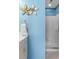 Stylish bathroom featuring a shower with a glass door and floral wall decor at 520 Weatherend Ct, Johns Creek, GA 30022
