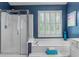 Bright bathroom featuring a separate shower and large tub beneath shuttered windows at 520 Weatherend Ct, Johns Creek, GA 30022